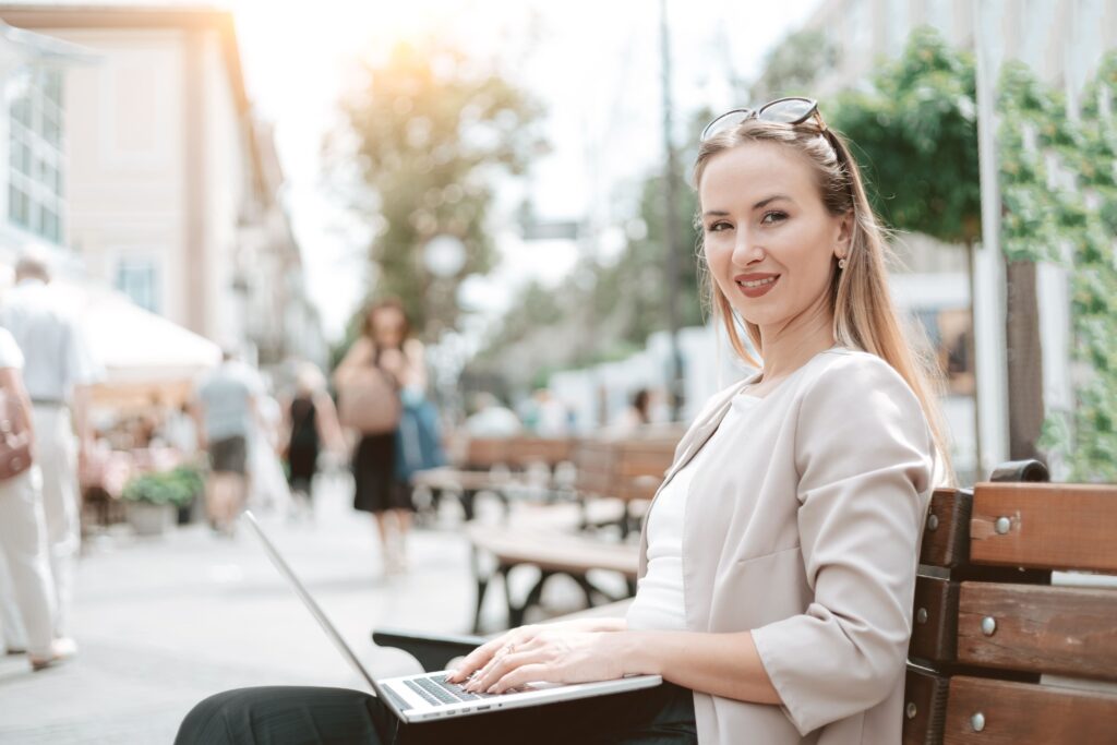 young woman with laptop sitting bench 1